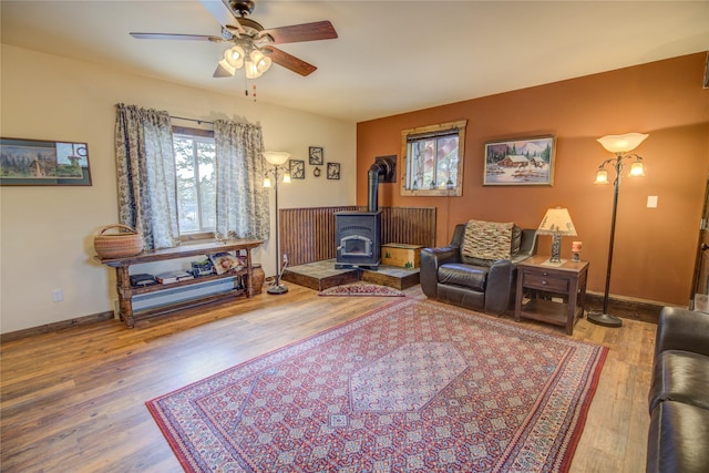 45 Bay Rd, Whitehall, MT 59759 - living area with a wood stove, wood finished floors, baseboards, and ceiling fan