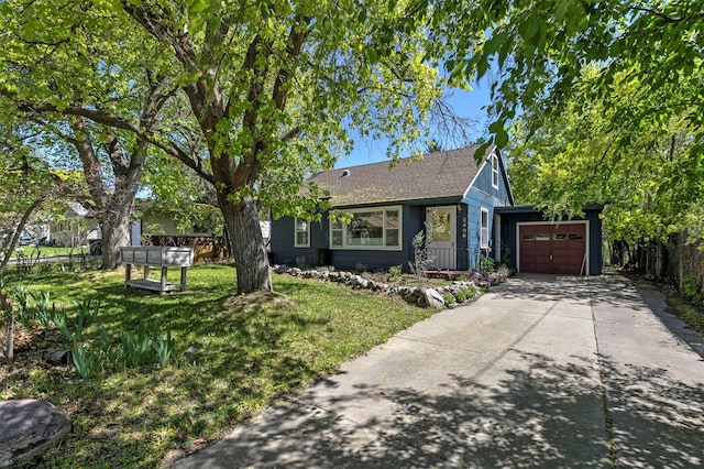 ranch-style home featuring fence, an attached garage, a shingled roof, concrete driveway, and a front yard