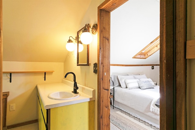 bathroom featuring vaulted ceiling and vanity