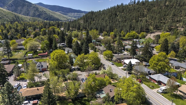 aerial view with a residential view, a mountain view, and a view of trees