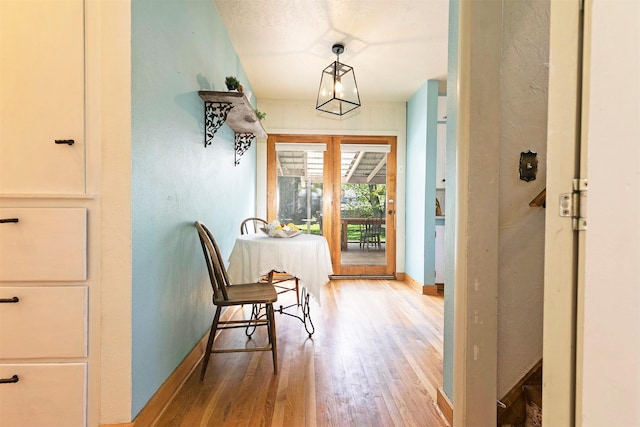 interior space featuring baseboards and wood finished floors