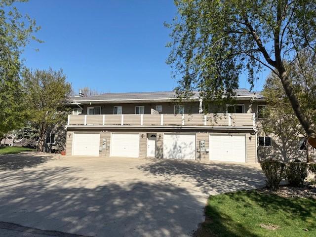 105 Garden Dr Unit D, Kalispell, MT 59901 - view of front property featuring driveway and a balcony