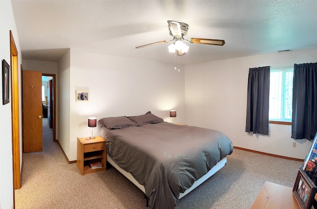 105 Garden Dr Unit D, Kalispell, MT 59901 - bedroom featuring light colored carpet, baseboards, ceiling fan, and visible vents