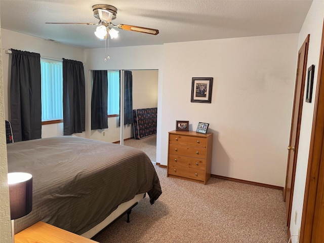 105 Garden Dr Unit D, Kalispell, MT 59901 - bedroom featuring a ceiling fan, light carpet, a closet, and baseboards