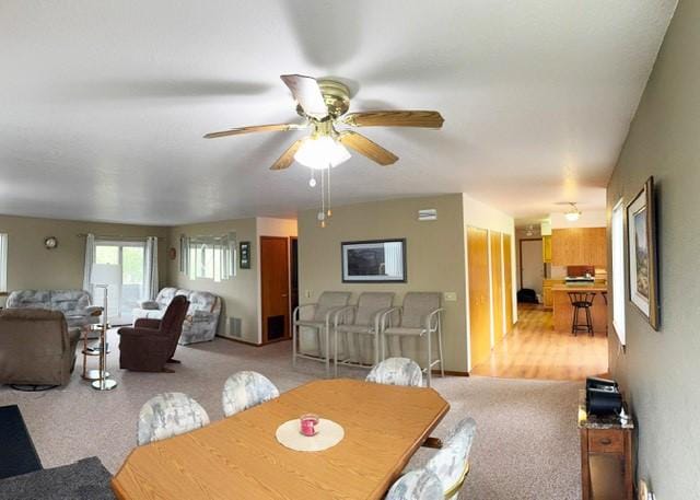 105 Garden Dr Unit D, Kalispell, MT 59901 - dining area featuring light carpet and a ceiling fan