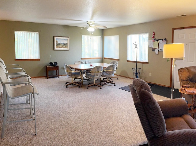 105 Garden Dr Unit D, Kalispell, MT 59901 - dining area featuring carpet flooring, baseboards, and a ceiling fan