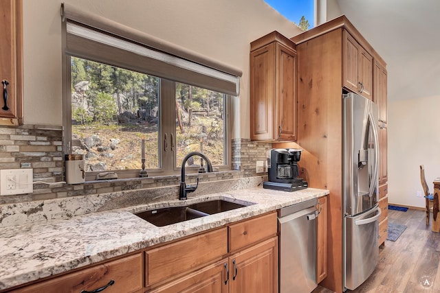617 Mcclellan Creek Rd, Clancy, MT 59634 - kitchen featuring stainless steel appliances, a sink, light stone counters, and healthy amount of natural light