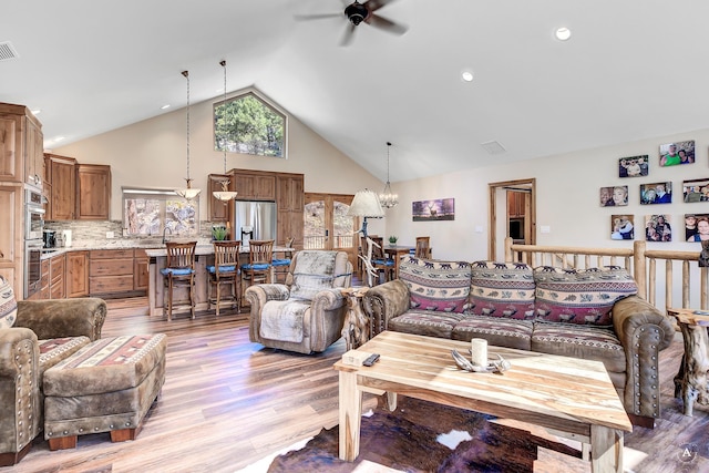 617 Mcclellan Creek Rd, Clancy, MT 59634 - living room featuring a ceiling fan, light wood finished floors, a chandelier, and high vaulted ceiling