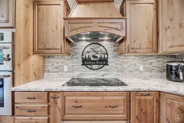 617 Mcclellan Creek Rd, Clancy, MT 59634 - kitchen with premium range hood, black electric cooktop, backsplash, double oven, and light stone counters