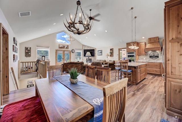 617 Mcclellan Creek Rd, Clancy, MT 59634 - dining space with a chandelier, light wood-type flooring, recessed lighting, and high vaulted ceiling