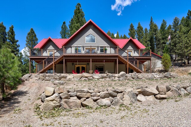 617 Mcclellan Creek Rd, Clancy, MT 59634 - back of house with stairs, a deck, and metal roof