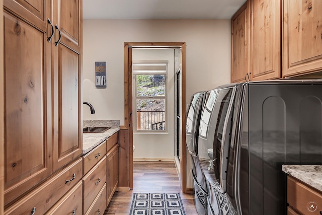 617 Mcclellan Creek Rd, Clancy, MT 59634 - laundry room with cabinet space, wood finished floors, and washer and clothes dryer