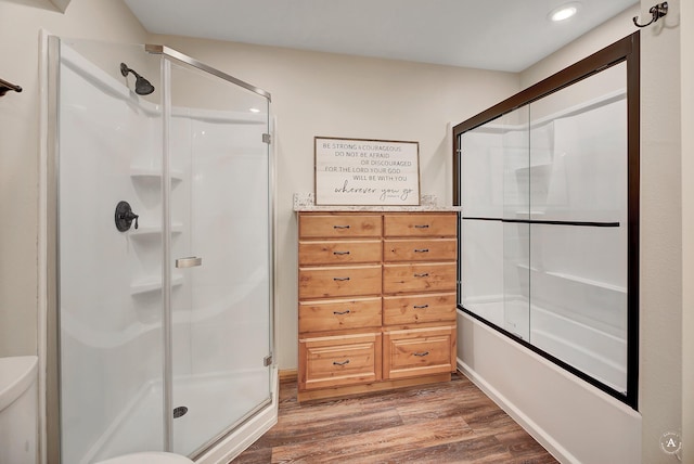 617 Mcclellan Creek Rd, Clancy, MT 59634 - full bath featuring wood finished floors, recessed lighting, toilet, and bath / shower combo with glass door