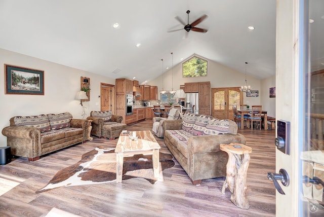 617 Mcclellan Creek Rd, Clancy, MT 59634 - living area with ceiling fan, high vaulted ceiling, light wood-type flooring, and a chandelier