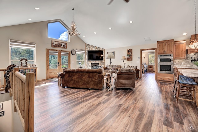617 Mcclellan Creek Rd, Clancy, MT 59634 - living area with wood finished floors, a fireplace, high vaulted ceiling, recessed lighting, and a ceiling fan
