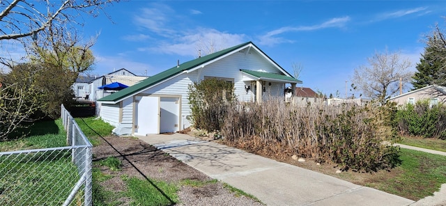 bungalow-style home with fence