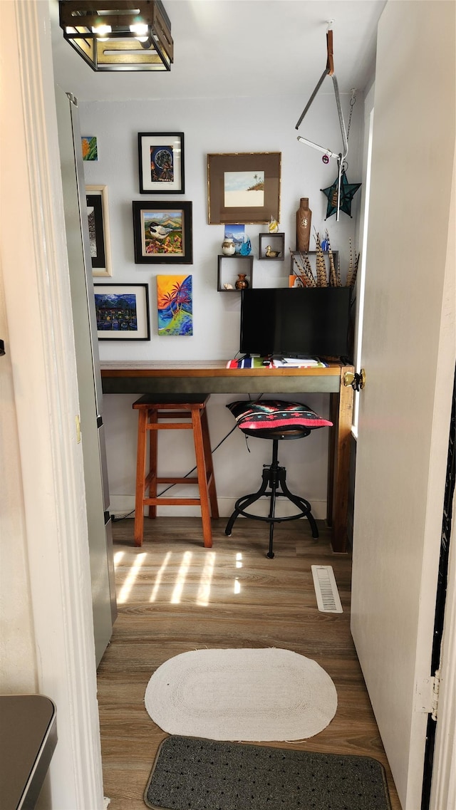 home office with wood finished floors