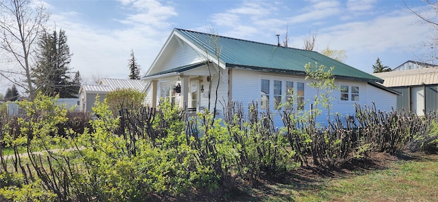 view of property exterior featuring metal roof