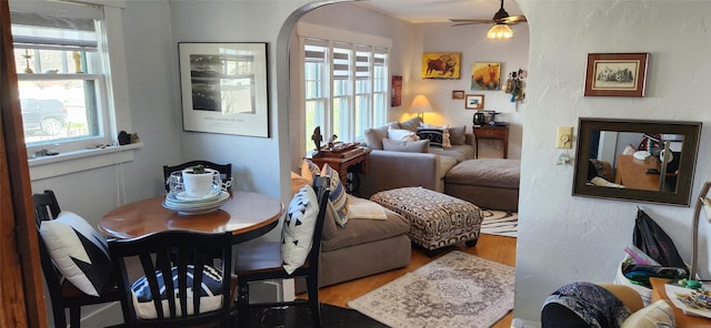 living room with wood finished floors and a ceiling fan