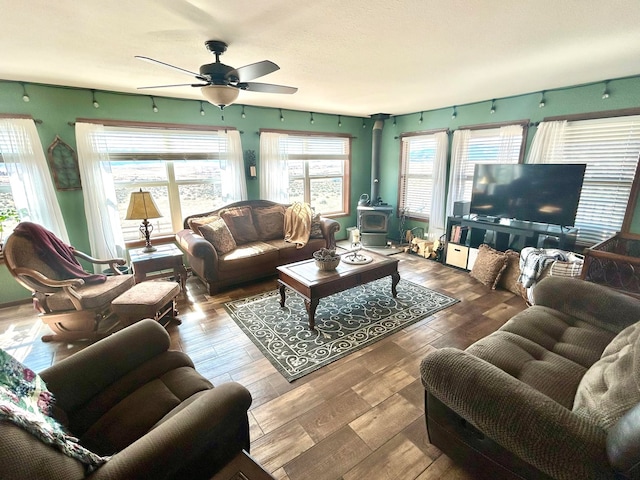 55 Mills Rd, Whitehall, MT 59759 - living area with a wood stove, ceiling fan, and wood finished floors