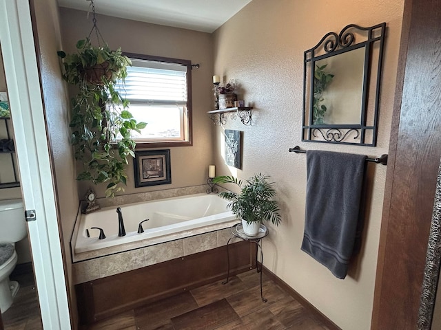 55 Mills Rd, Whitehall, MT 59759 - full bathroom with toilet, a bath, and wood finished floors