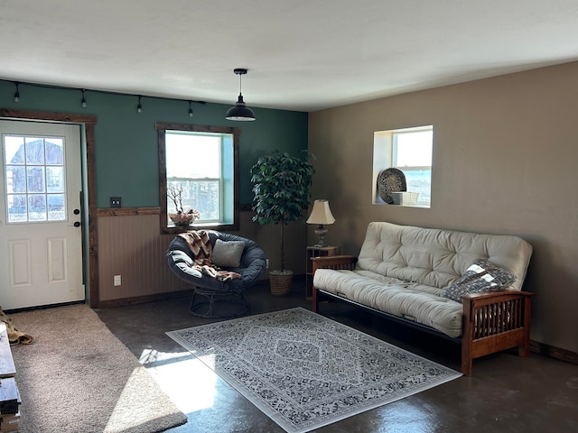 55 Mills Rd, Whitehall, MT 59759 - living area featuring plenty of natural light, finished concrete flooring, and a wainscoted wall