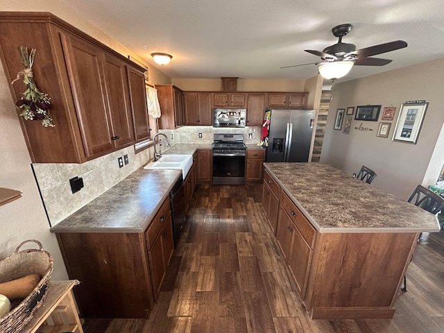 55 Mills Rd, Whitehall, MT 59759 - kitchen featuring appliances with stainless steel finishes, a sink, dark wood finished floors, decorative backsplash, and a ceiling fan