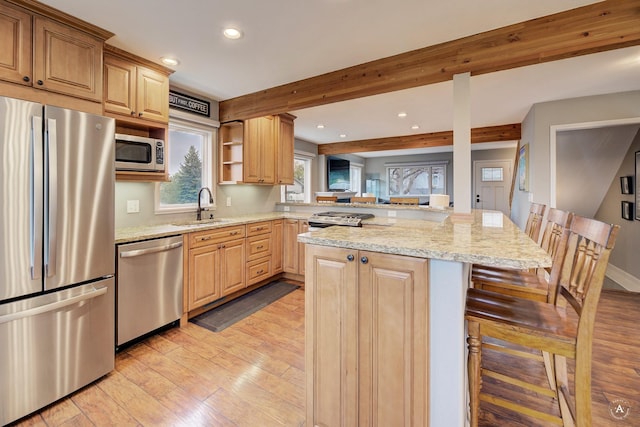 710 Joslyn St, Helena, MT 59601 - kitchen with stainless steel appliances, light wood-style flooring, a kitchen breakfast bar, recessed lighting, and light stone counters