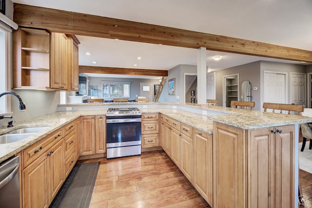710 Joslyn St, Helena, MT 59601 - kitchen with stainless steel appliances, beamed ceiling, recessed lighting, light brown cabinets, and light wood-style flooring