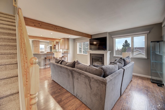 710 Joslyn St, Helena, MT 59601 - living area with stairs, light wood finished floors, beamed ceiling, a glass covered fireplace, and recessed lighting