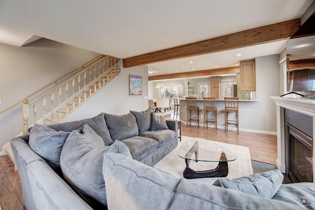 710 Joslyn St, Helena, MT 59601 - living area with recessed lighting, stairs, beamed ceiling, wood finished floors, and a fireplace