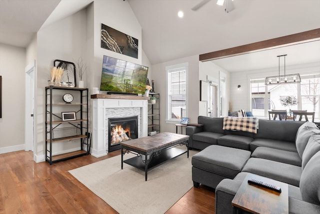 200 Ali Loop, Kalispell, MT 59901 - living room with a glass covered fireplace, wood finished floors, ceiling fan, a chandelier, and recessed lighting
