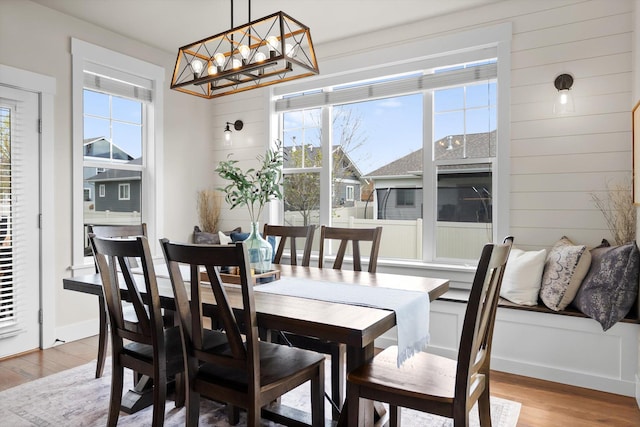 200 Ali Loop, Kalispell, MT 59901 - dining area with light wood-style flooring, a chandelier, and wooden walls