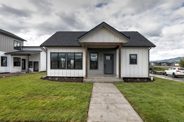NHNLOT2 England Blvd, Missoula, MT 59808 - view of front of property featuring board and batten siding, roof with shingles, and a front yard