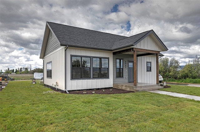 NHNLOT2 England Blvd, Missoula, MT 59808 - modern farmhouse style home with a shingled roof, a front yard, and board and batten siding