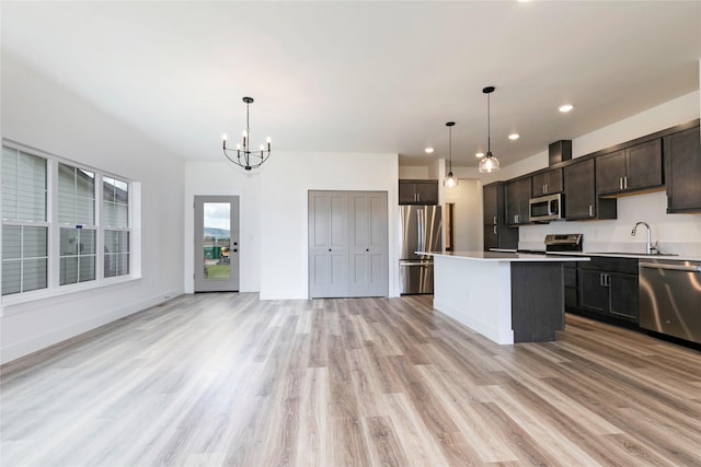 NHNLOT2 England Blvd, Missoula, MT 59808 - kitchen with appliances with stainless steel finishes, a sink, light wood-type flooring, recessed lighting, and dark brown cabinetry