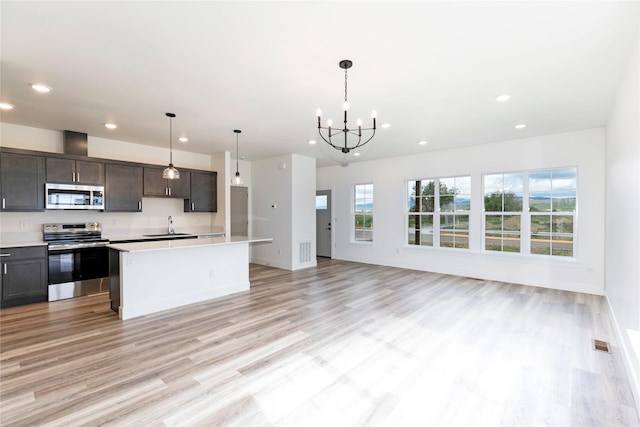 NHNLOT2 England Blvd, Missoula, MT 59808 - kitchen featuring stainless steel appliances, recessed lighting, light countertops, light wood finished floors, and a chandelier