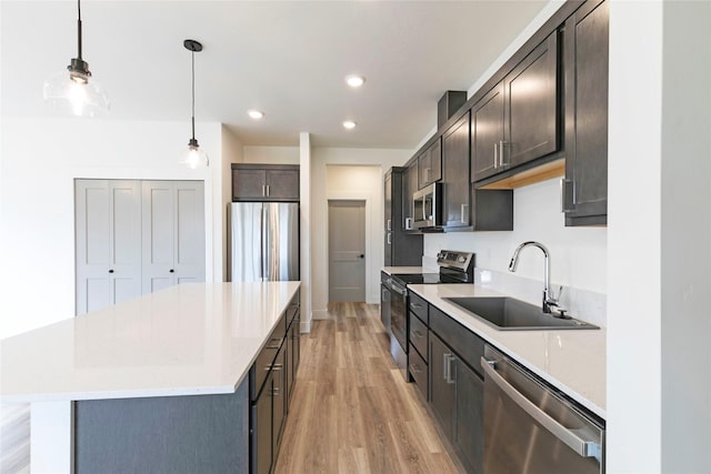 NHNLOT2 England Blvd, Missoula, MT 59808 - kitchen featuring stainless steel appliances, a sink, a center island, light wood-style floors, and recessed lighting
