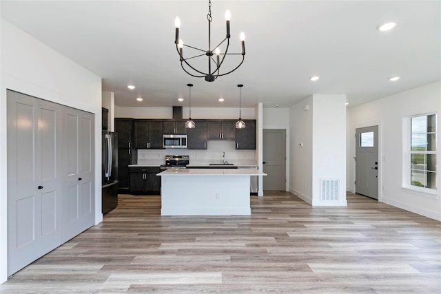 NHNLOT2 England Blvd, Missoula, MT 59808 - kitchen with appliances with stainless steel finishes, a sink, light countertops, recessed lighting, and a chandelier