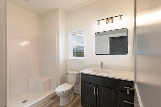 NHNLOT2 England Blvd, Missoula, MT 59808 - full bathroom featuring wood finished floors, vanity, toilet, a shower, and baseboards
