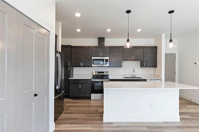 NHNLOT2 England Blvd, Missoula, MT 59808 - kitchen featuring appliances with stainless steel finishes, a sink, light countertops, light wood finished floors, and recessed lighting