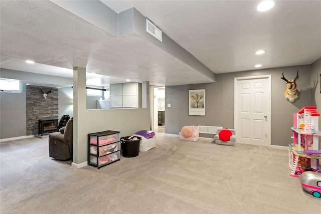 recreation room with carpet, a fireplace, baseboards, and recessed lighting