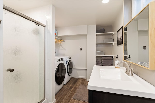 washroom with separate washer and dryer, a sink, and dark wood finished floors