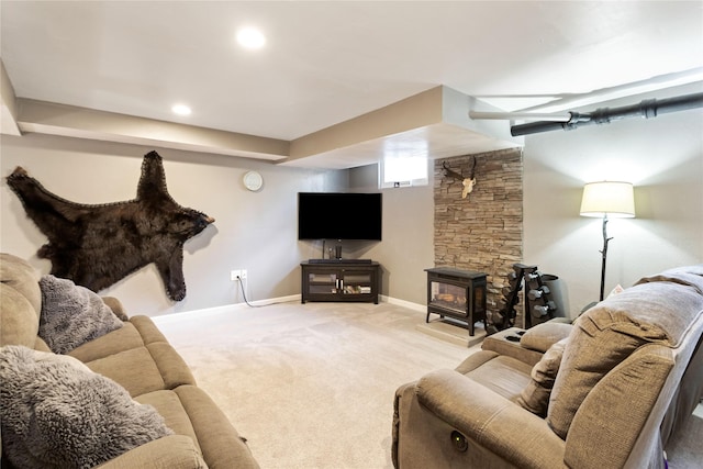 living room with light carpet, baseboards, and a wood stove