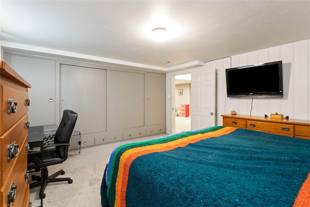 bedroom featuring carpet flooring, an office area, and a closet