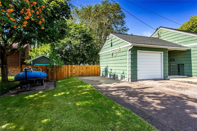 view of yard featuring driveway and an attached garage