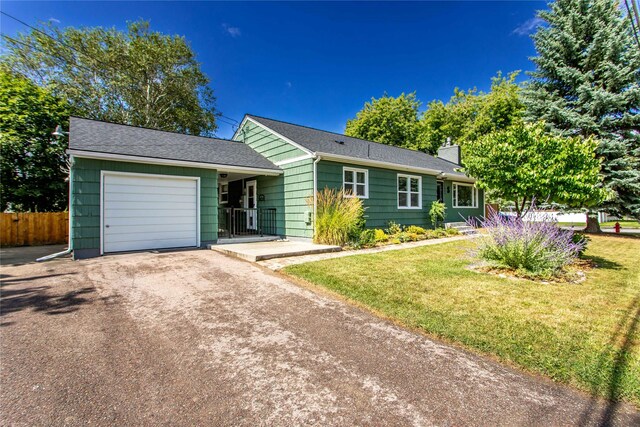 1004 Park Ave, Whitefish, MT 59937 - ranch-style house with asphalt driveway, a garage, and a chimney