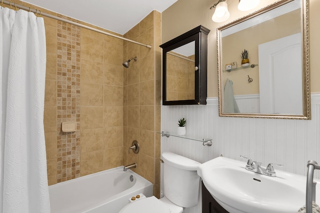 full bathroom featuring shower / bath combo, toilet, a wainscoted wall, and vanity