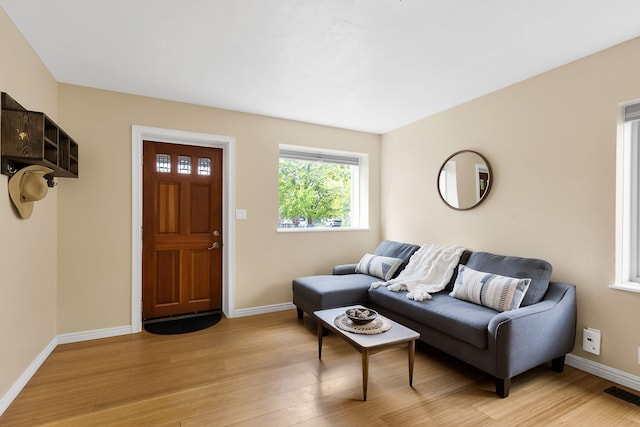 living room featuring light wood-style floors and baseboards