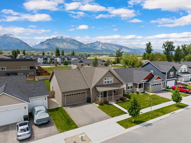 203 Kismet Ct, Hamilton, MT 59840 - view of front of home with a residential view, a mountain view, asphalt driveway, and a garage